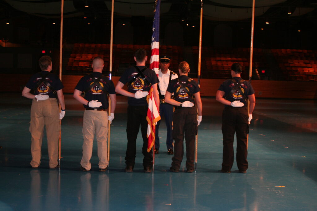 Five Columbia Police Officers face the flag and salute